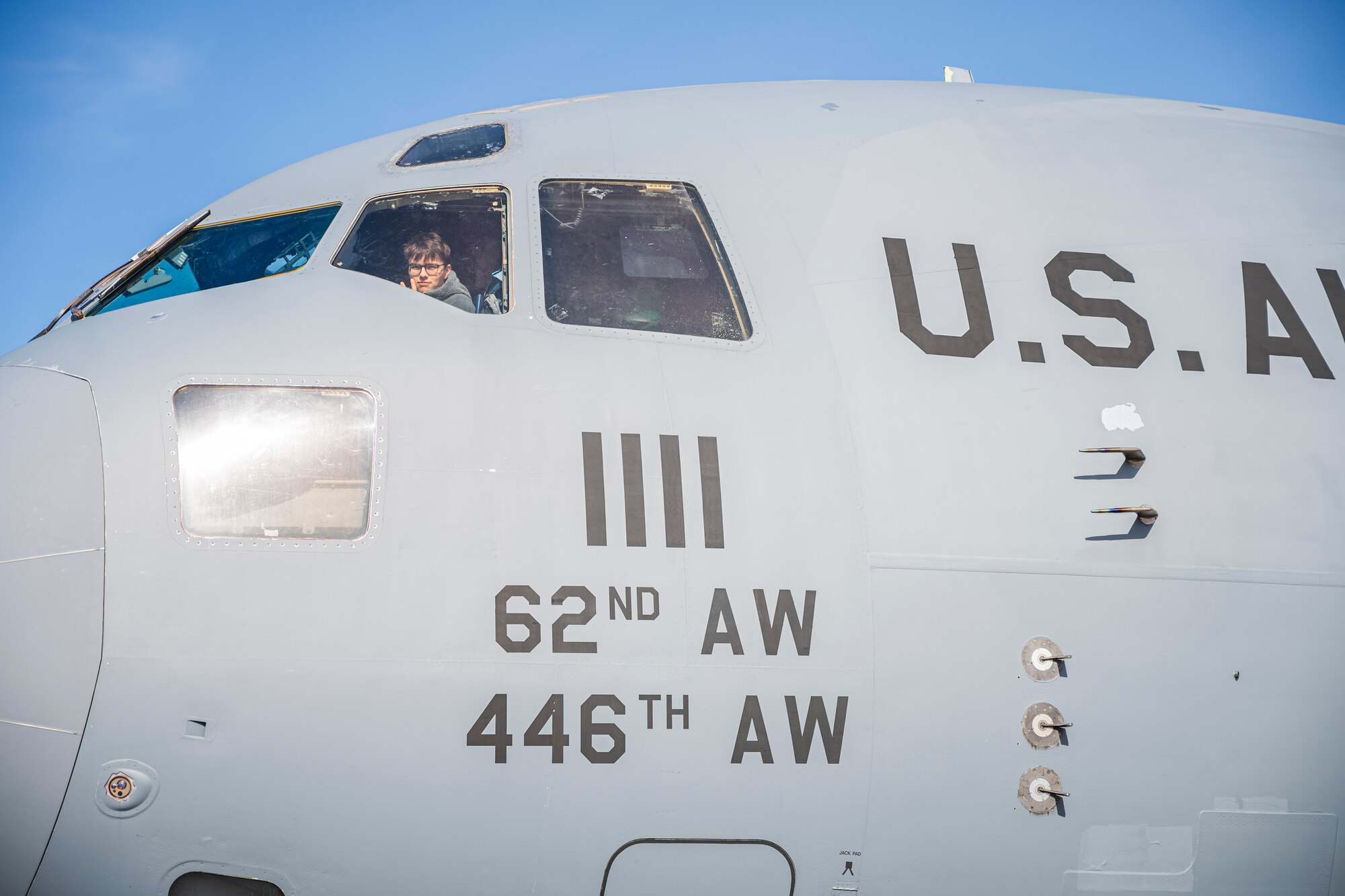 A student from the Big Bend Community College aviation program looks out the flight deck window while sitting in the pilot seat of a 62d Airlift Wing C-17 Globemaster III after a McChord Flight Safety Office midair collision avoidance brief in Moses Lake, Washington, March 7, 2025.