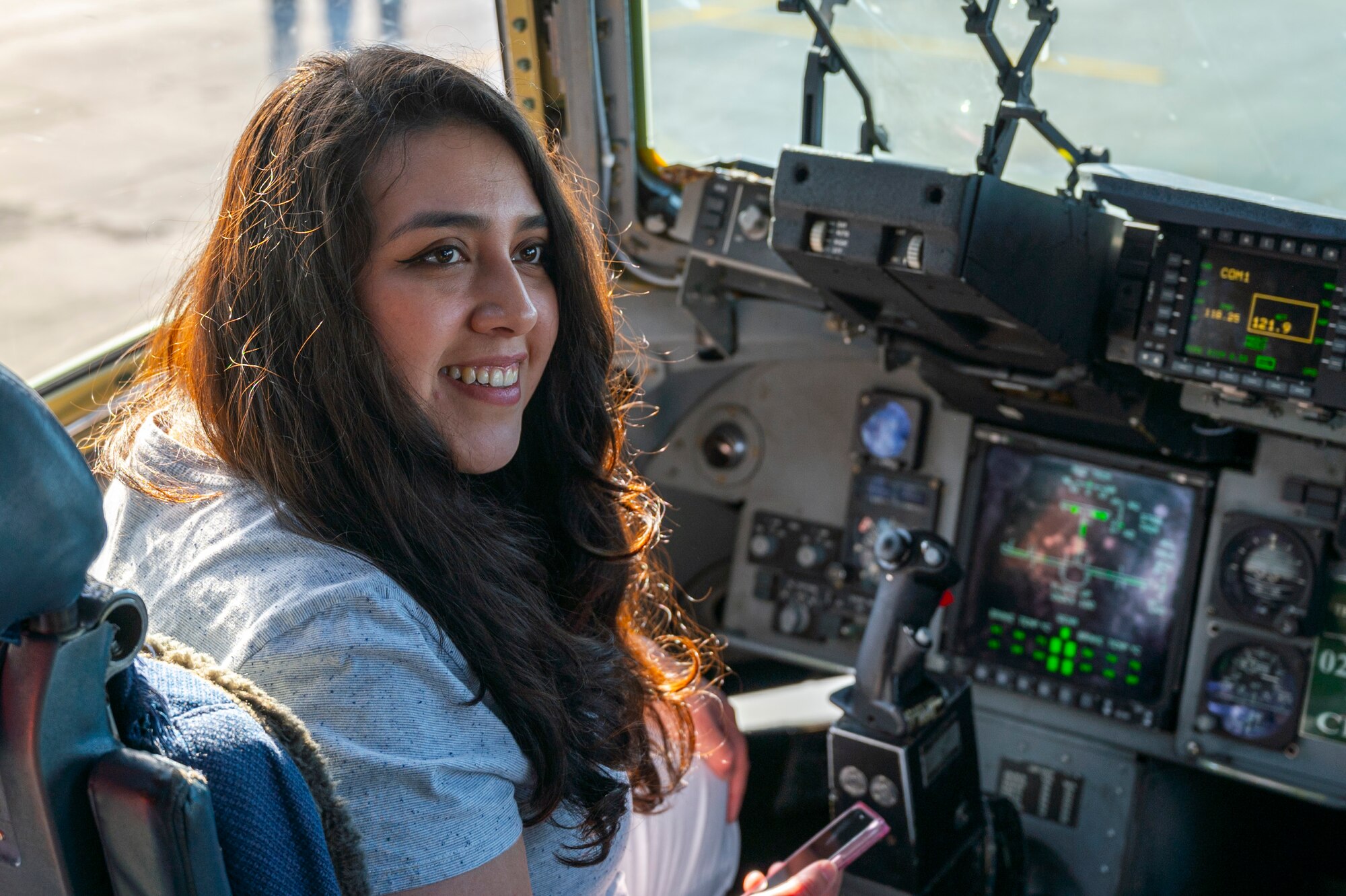 A student from the Big Bend Community College aviation program smiles while sitting in the pilot seat of a 62d Airlift Wing C-17 Globemaster III after a McChord Flight Safety Office midair collision avoidance brief in Moses Lake, Washington, March 7, 2025.