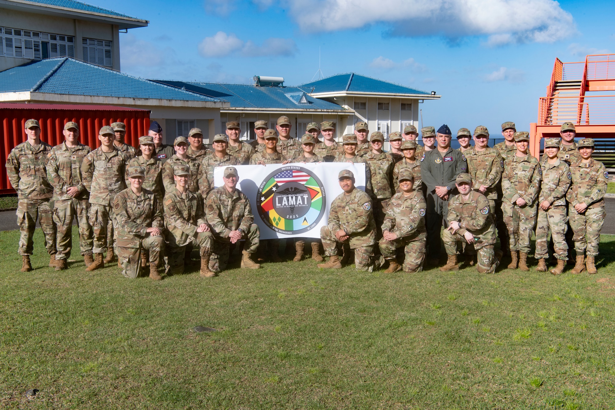 The Lesser Antilles Medical Assistance Team (LAMAT) 2025 stand outside Owen King European Union (OKEU) Hospital for a group photo at Castries, Saint Lucia, Feb. 26, 2025. LAMAT stands as a symbol of partnership through medical readiness, offering real-world benefits to achieve positive outcomes through collaboration with partner nations. (US Air Force photo by Tech. Sgt. Ryan Green)