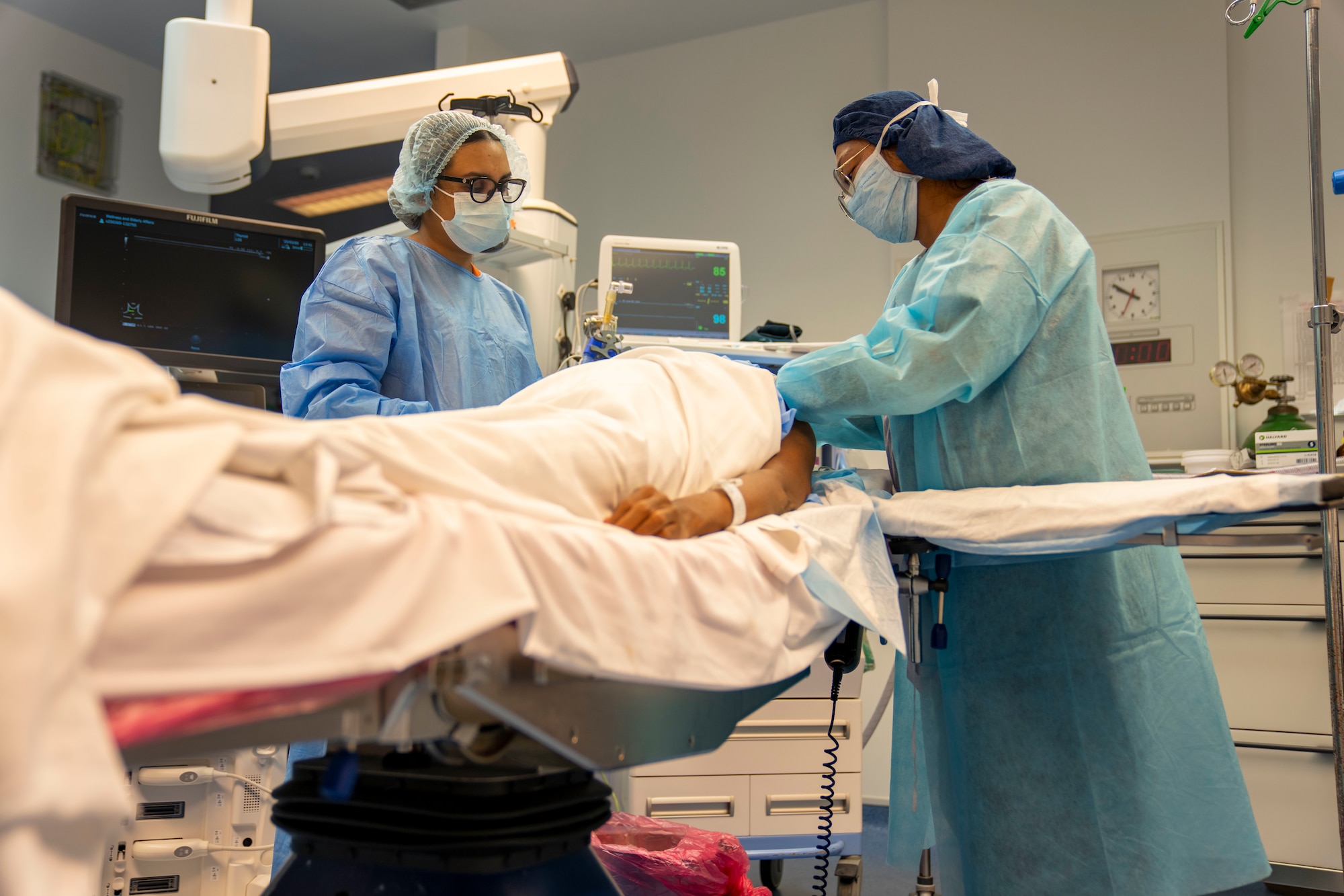 Lesser Antilles Medical Assistance Team members conduct an ultrasound-guided nerve block on a patient during the LAMAT mission at Owen King European Union Hospital in Castries, Saint Lucia, March 5, 2025. The nerve block procedure blocks pain from reaching specific nerves and can speed recovery and reduce need for post-surgery pain medication. LAMAT fosters collaboration between U.S. and host nation medical teams to facilitate knowledge sharing and skills transfer, strengthening the host nation's own healthcare capabilities. (U.S. Air Force photo by Andrea Jenkins)