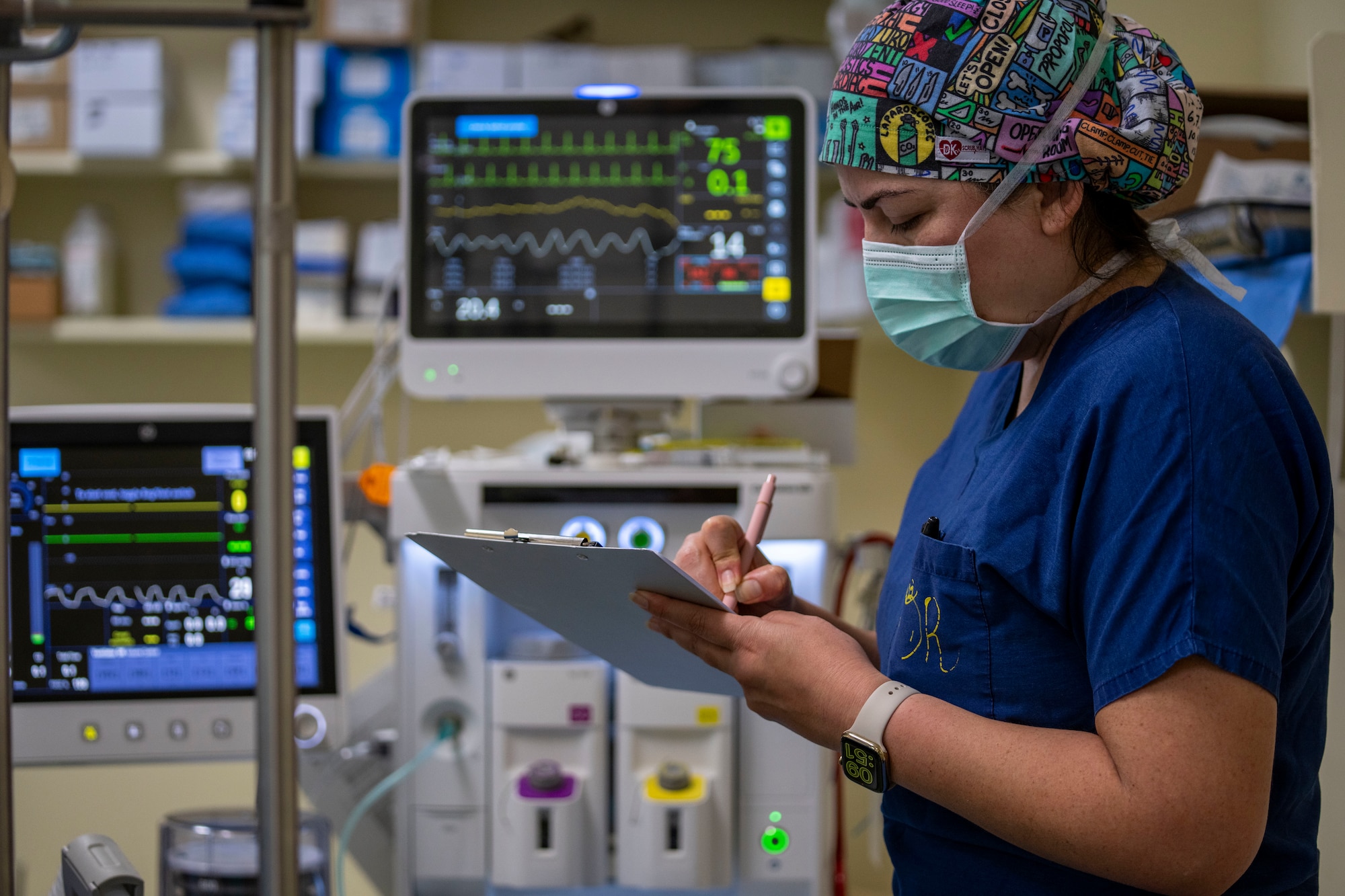 Capt. Mayra Mendoza, 349th Medical Squadron certified registered nurse anesthetist, documents vital signs and surgical milestones throughout an Arteriovenous Fistula procedure during the Lesser Antilles Medical Assistance Team mission at St. Jude Hospital in Vieux Fort, Saint Lucia, March 4, 2025. LAMAT fosters collaboration between U.S. and host nation medical teams in order to facilitate knowledge sharing and skills transfer, strengthening the host nation's own healthcare capabilities. (U.S. Air Force photo by Andrea Jenkins)