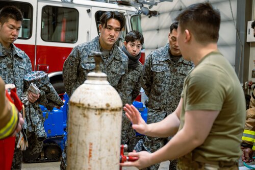 Japan Air Self-Defense Force firefighters observe a HAZMAT containment demonstration by a U.S. Air Force member assigned to the 35th Fighter Wing during a bilateral HAZMAT training exercise at Misawa Air Base, Japan, March 7, 2025. The training reinforced knowledge-sharing and strengthened emergency response collaboration by allowing participants to familiarize themselves with each other’s equipment, refine joint operational procedures, and improve their ability to respond swiftly and effectively to hazardous material incidents. (U.S. Air Force photo by Senior Airman William Rodriguez)
