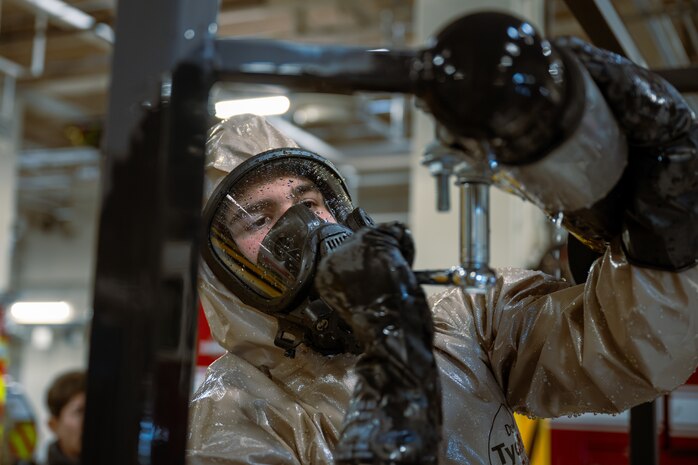 A U.S. Air Force firefighter assigned to the 35th Fighter Wing secures a simulated pipe leak during a bilateral HAZMAT training exercise at Misawa Air Base, Japan, March 7, 2025.