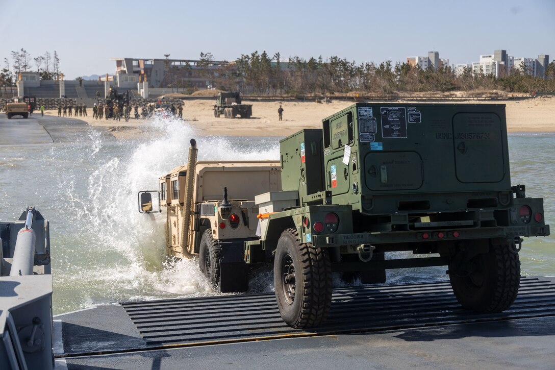 A High Mobility Multi-Purpose Wheeled Vehicle with 3rd Marine Logistics Group departs an Improved Navy Lighterage System during a 3rd MLG instream offload operation as part of Freedom Banner 25 at Republic of Korea Marine Corps Base Pohang, South Korea, Feb. 28, 2025. The instream offload, a training evolution alongside Beachmaster Unit 1, Naval Beach Group 1, and the ROKMC Marine Logistics Group, refines and validates 3rd MLG’s ability to transport, offload and distribute vehicles and equipment from ship to shore without the use of a pier. This type of sealift capability allows the unit to maneuver equipment in austere environments without using established infrastructure, such as in locations following a natural disaster. Freedom Banner 25 is a Maritime Prepositioning Force exercise where 3rd MLG offloads equipment and provides support to III Marine Expeditionary Force units training throughout South Korea, testing and validating 3rd MLG’s ability to conduct integrated logistics operations in complex environments. (U.S. Marine Corps photo by Gunnery Sgt. Jonathan G. Wright)