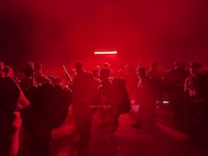 Trainees line up under the red light at the start of PACER FORGE