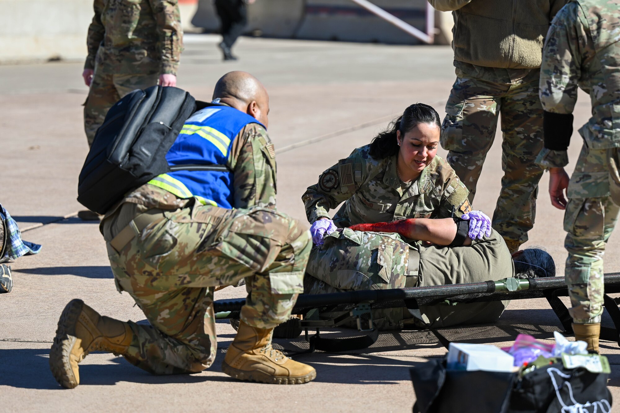 U.S. Air Force Master Sgt. Monserat Bravo-Ponce, 97th Operational Medical Readiness Squadron senior enlisted leader, positions a patient onto a stretcher during a Sustainment Operations for Air Force Medical Responders exercise at Altus Air Force Base, Oklahoma, Feb. 27, 2025.