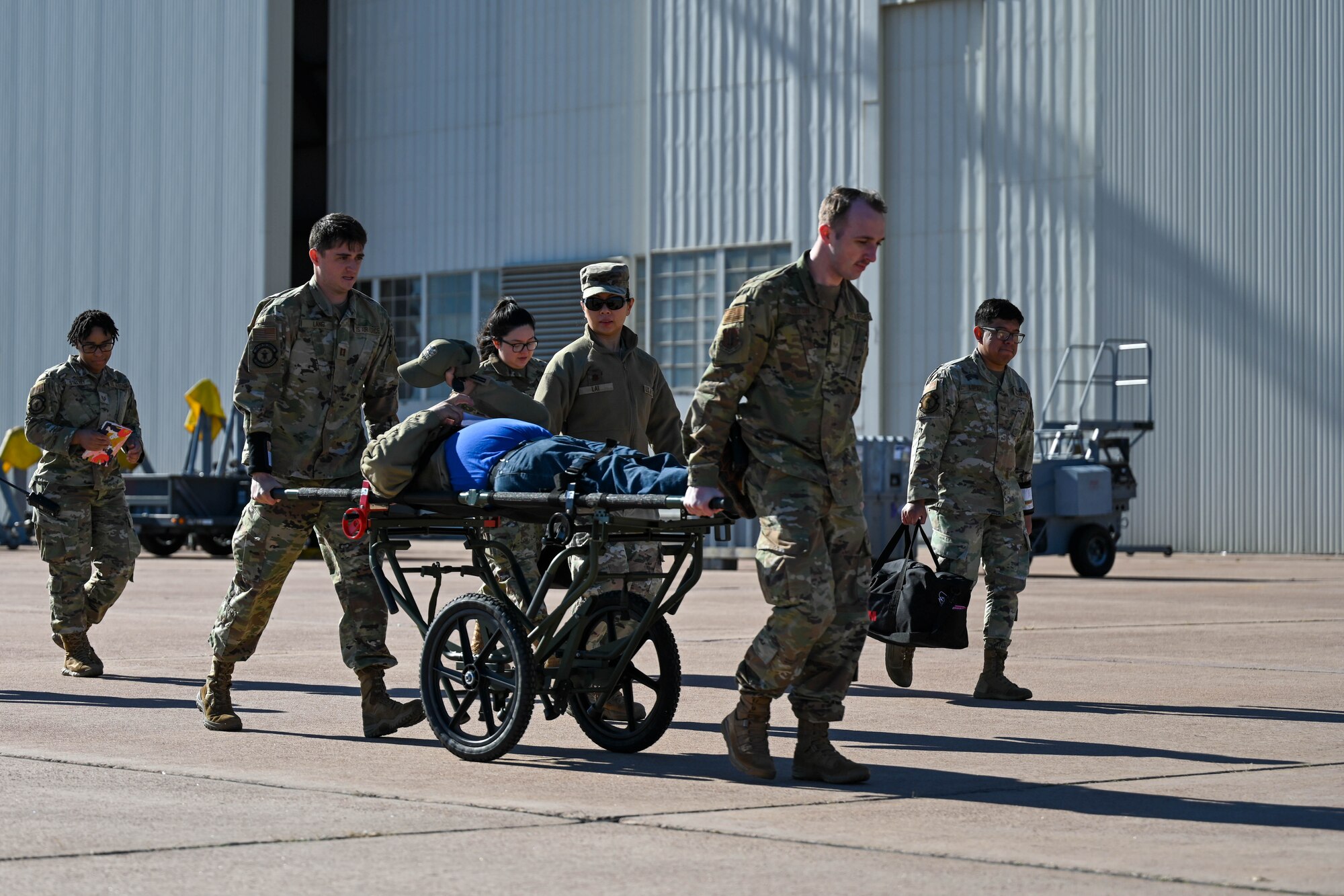 U.S. Air Force Airmen from the 97th Medical Group roll a man on a stretcher during an exercise at Altus Air Force Base, Oklahoma, Feb. 27, 2025.