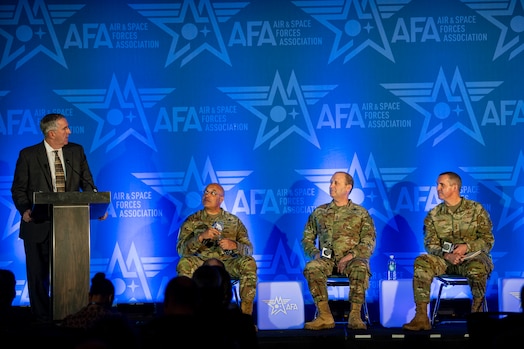  Four people take the stage at a conference.