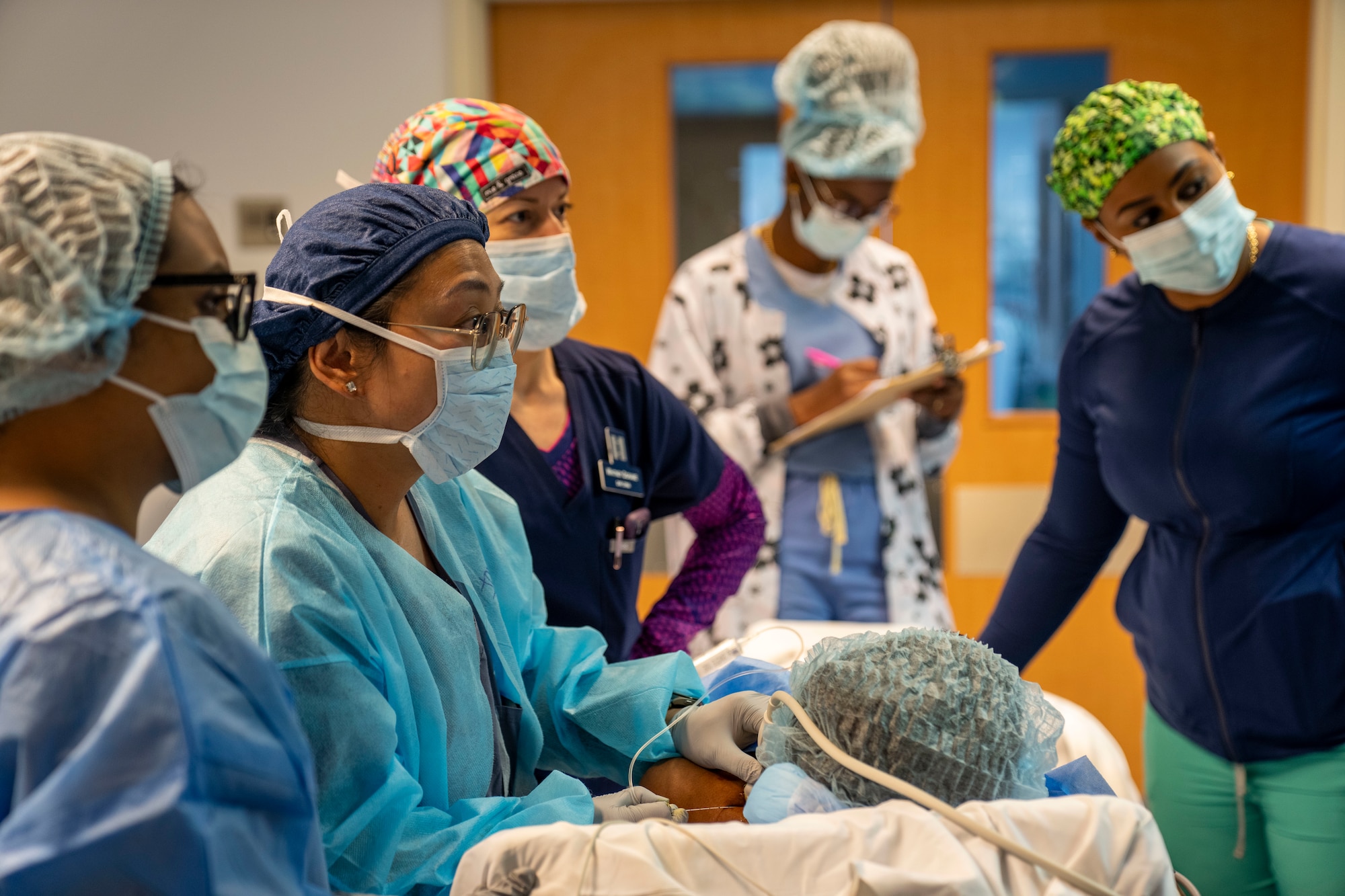 Medical professionals conduct an ultrasound-guided nerve block on a patient during the Lesser Antilles Medical Assistance Team mission at Owen King European Union Hospital in Castries, Saint Lucia, March 5, 2025. The nerve block procedure blocks pain from reaching specific nerves and can speed recovery and reduce need for post-surgery pain medication. LAMAT fosters collaboration between U.S. and host nation medical teams to facilitate knowledge sharing and skills transfer, strengthening the host nation's own healthcare capabilities. (U.S. Air Force photo by Andrea Jenkins)