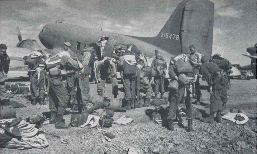 U.S. Army Signal Corps depicts 511th Parachute Infantry Regiment paratroopers staging gear in Mindoro, Philippines, Feb. 3, 1945. The 511th PIR, part of the 11th Airborne Division, prepared for a mass combat airdrop with the 317th Troop Carrier Group over Tagaytay Ridge in Luzon, Philippines, in support of the liberation of the Japanese-occupied capital, Manila. The joint cooperation to liberate and defend the Philippines was critical to U.S. victory in the Pacific Theater. (Photo by Courtesy Photo)