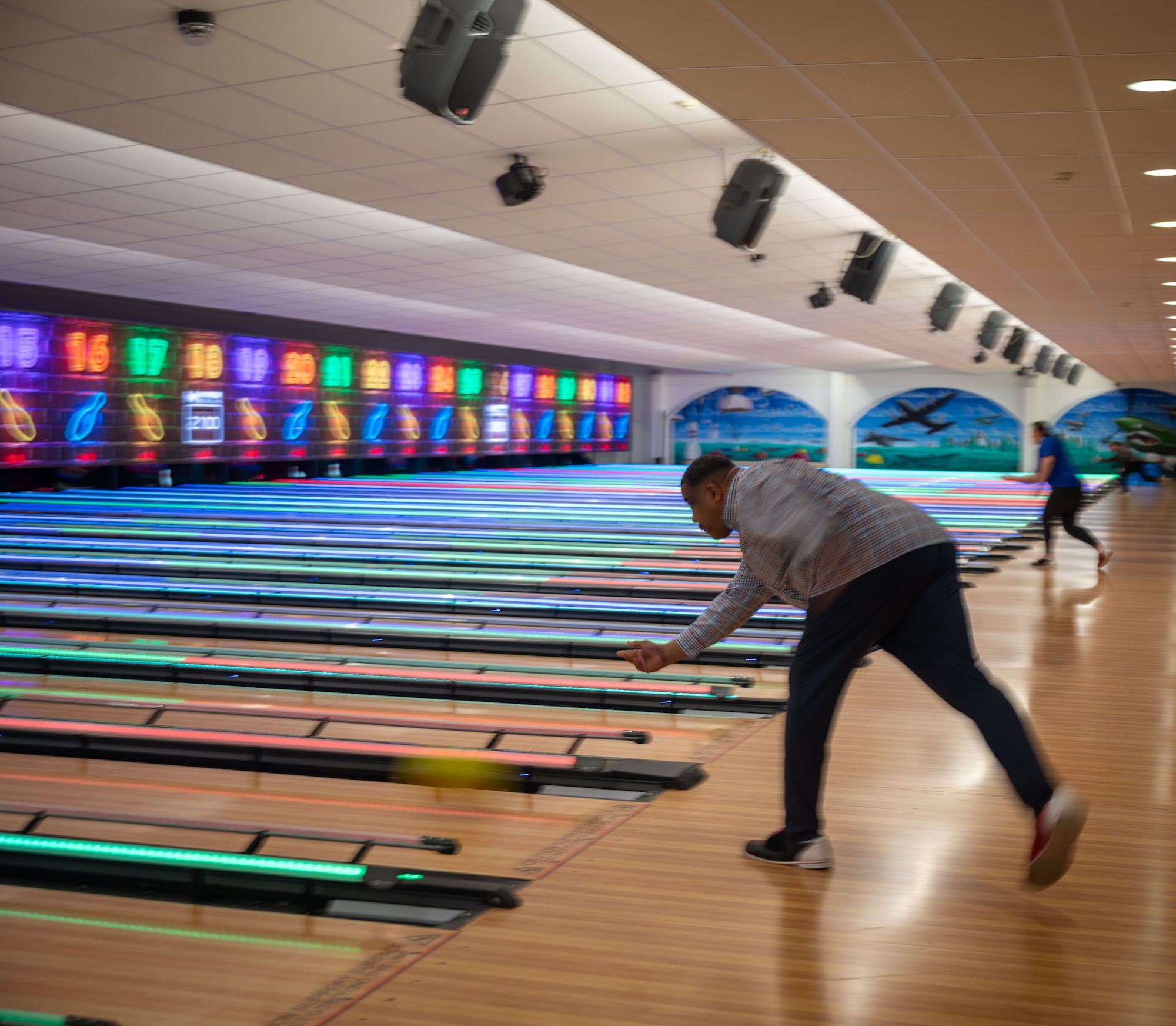 Man bowls at bowling alley