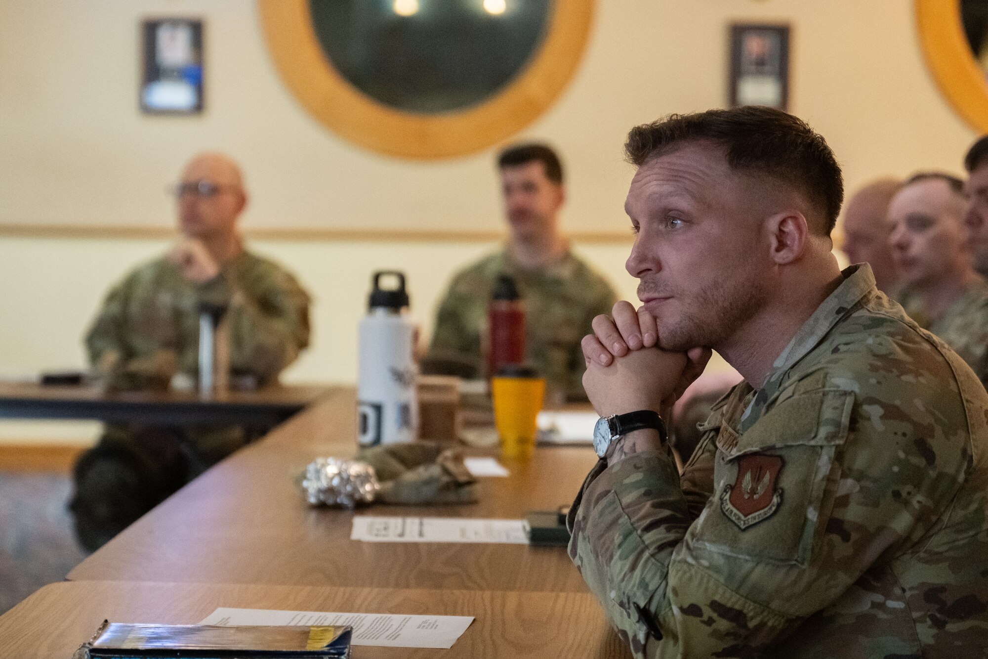 U.S. Air Force Master Sgt. Corey Armstrong, 100th Logistics Readiness Squadron fuels superintendent, listens to a briefing about the new shaving waiver guidance at RAF Mildenhall, England, Feb. 26, 2025.