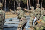Firers stand and engage their targets during a pistol competition at Grafenwoehr Training Area, March 9, 2025. U.S. Soldiers with the 2nd Cavalry Regiment and the 7th Army Training Command joined the 56th Stryker Brigade Combat Team at the competition.