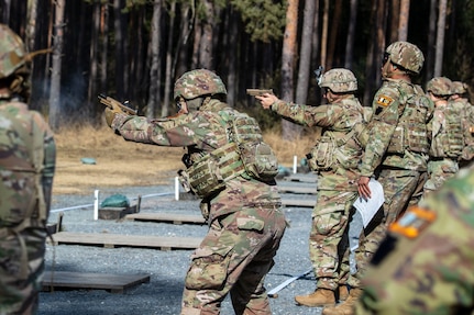 Firers stand and engage their targets during a pistol competition at Grafenwoehr Training Area, March 9, 2025. U.S. Soldiers with the 2nd Cavalry Regiment and the 7th Army Training Command joined the 56th Stryker Brigade Combat Team at the competition.