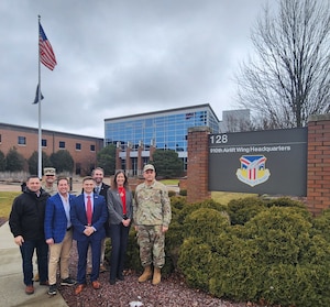 Members of the Ohio House of Representatives’ Veterans and Military Development Committee pose for a photo with Capt. Donnie Hatheway, 910th Airlift Wing public affairs chief (left – back row), and Senior Master Sgt. Bob Barko Jr., 910th public affairs superintendent (right - front row), in front of the wing headquarters building at Youngstown Air Reserve Station, Ohio, Feb. 27, 2025.