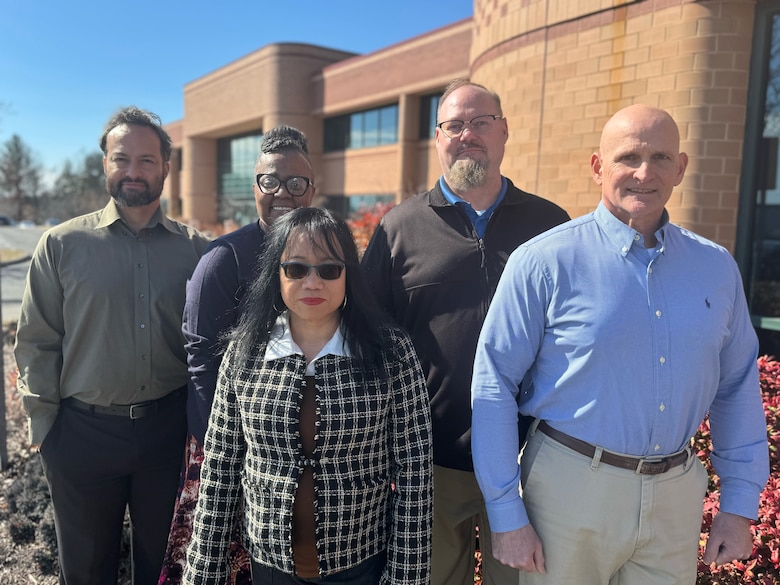 Roger Vogler stands for a group photo with other professionals.
