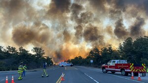 Members of the New York Air National Guard's 106th Rescue Wing Fire Department and other local fire departments respond to the Pine Barrens fire off Sunrise Highway on Long Island, N.Y., March 8, 2025.