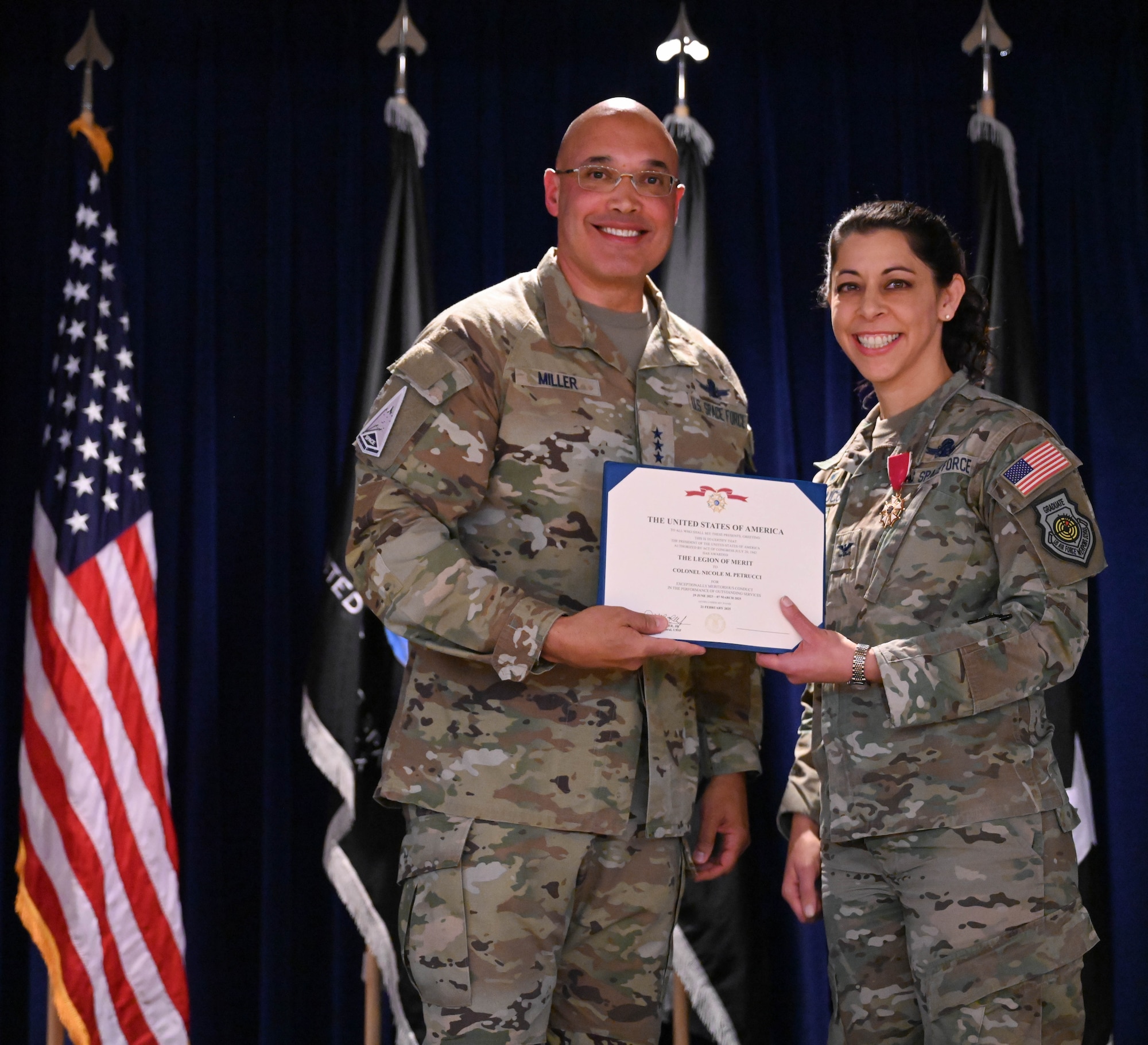 U.S. Space Force Lt. Gen. David N. Miller, Jr., Space Operations Command commander, left, presents Col. Nicole Petrucci, outgoing Mission Delta 3 commander, with the Legion of Merit during the MD 3’s change of command ceremony at Peterson Space Force Base, Colorado, March 7, 2025. During Petrucci’s command, the unit transitioned to a provisional integrated mission delta construct, now mission delta, that organizes service activities around mission areas instead of functional specialties to ensure mission requirements, organizational concepts, training, logistics, sustainment, and doctrinal implications were considered from a warfighter perspective during force design. (U.S. Space Force photo by Staff Sgt. Jaime Sanchez)