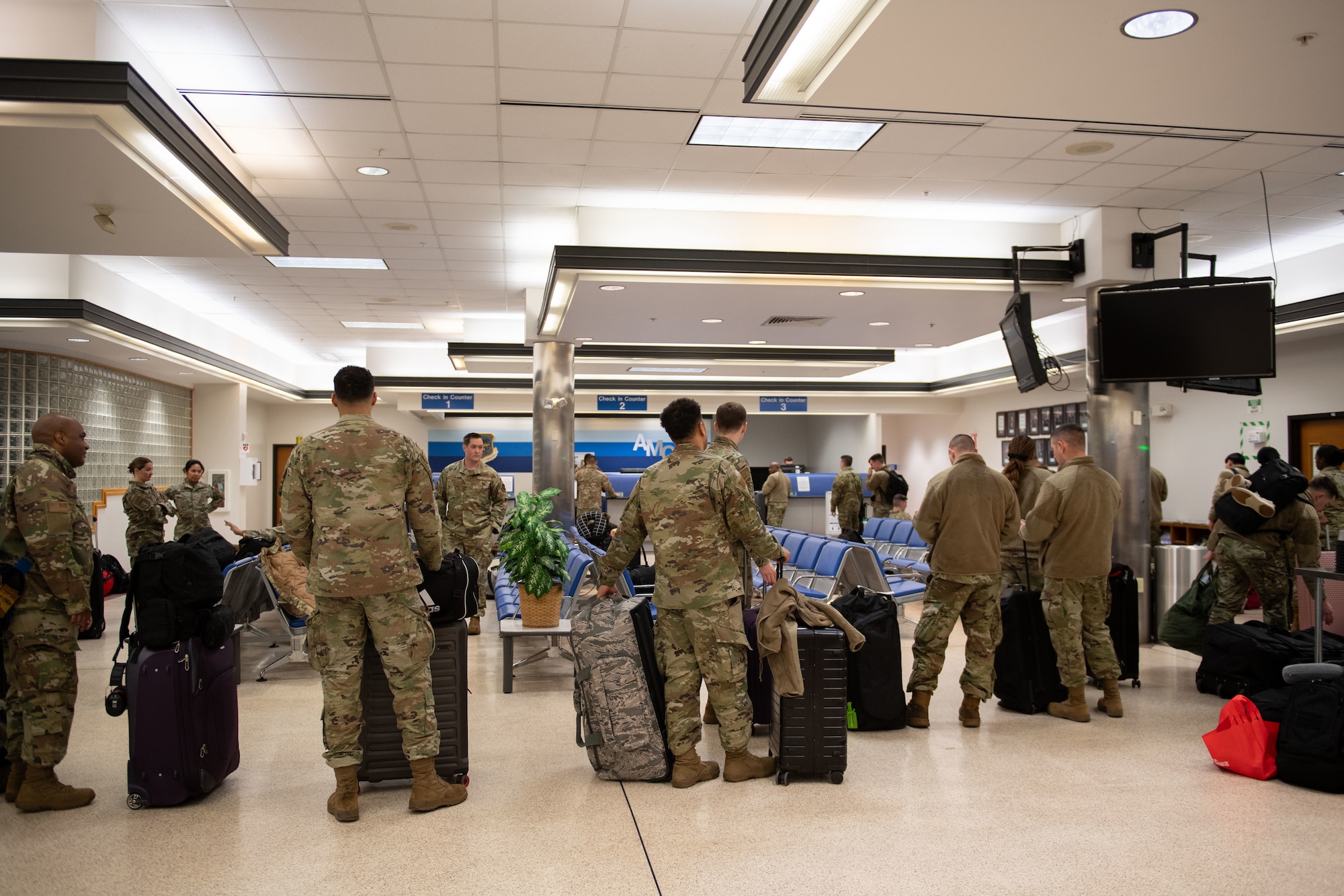 Airmen from the 512th Maintenance and Aircraft Maintenance Squadrons and 712th Aircraft Maintenance Squadron wait to have their bags checked at the Passenger Terminal at Dover Air Force Base, Delaware, Mar. 8, 2025. At the 436th Aerial Port Squadron Passenger Terminal, active duty, reserve, guard, disabled veterans, retirees and their dependents can travel overseas on the C-5M Super Galaxy and the C-17 Globemaster III, at a low cost. (U.S. Air Force photo by Airman 1st Class Liberty Matthews)