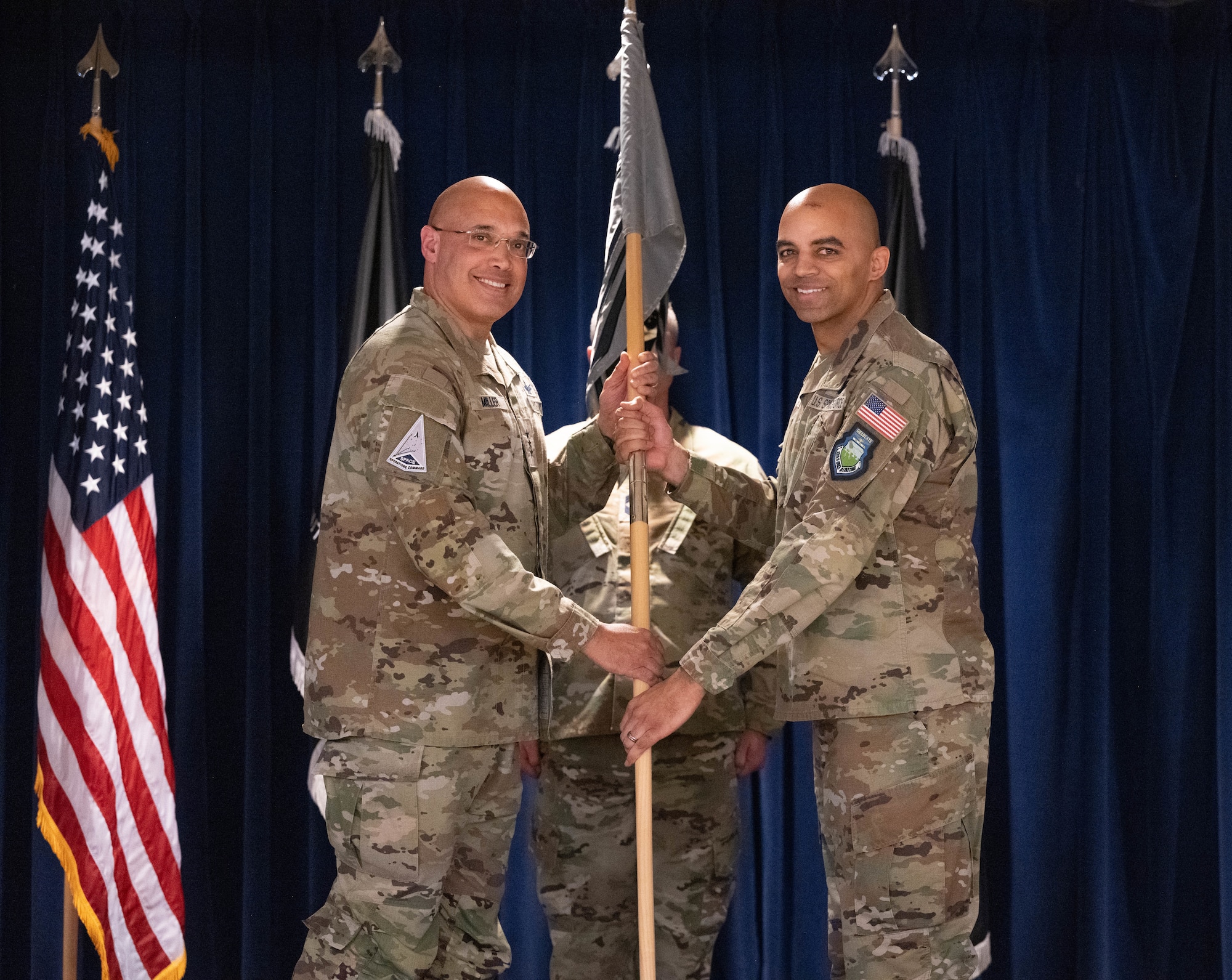 U.S. Space Force Lt. Gen. David N. Miller, Jr., Space Operations Command commander, left, presents the guidon to Col. Angelo Fernandez, incoming Mission Delta 3 commander, during MD 3’s change of command at Peterson Space Force Base, Colorado, March 7, 2025. The units now falling under Fernandez’s command include the 4th, 5th, 16th, and 23rd Electromagnetic Warfare Squadrons, the 37th Tactical Intelligence Squadron, and the 3rd Combat Training Squadron. MD 3 prepares and presents combat-ready space electromagnetic warfare professionals to integrate, synchronize, and execute fires for U.S., Allied, and Coalition forces. (U.S. Space Force photo by Staff Sgt. Jaime Sanchez)