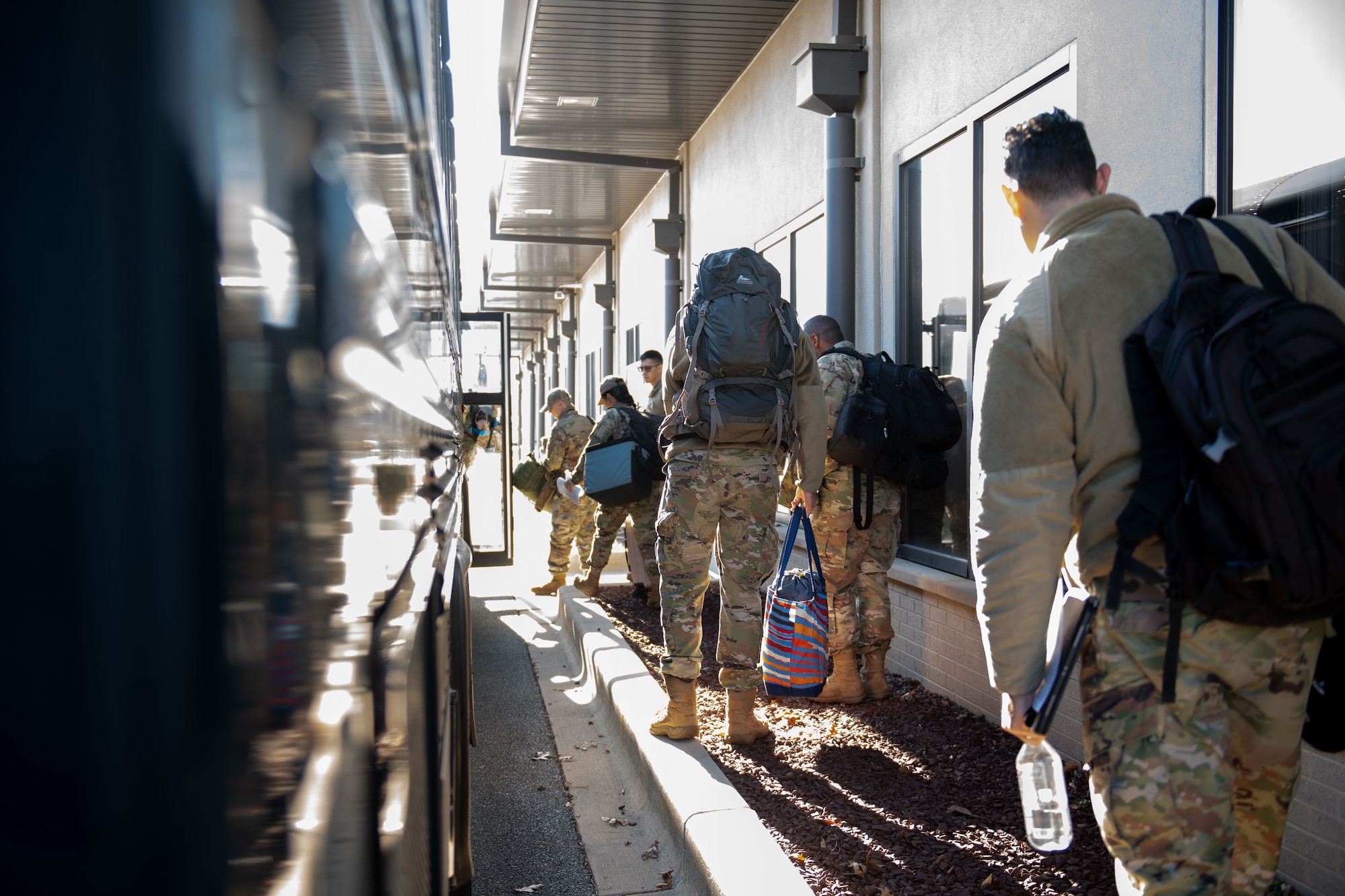 Airmen from the 512th Maintenance and Aircraft Maintenance Squadrons and 712th Aircraft Maintenance Squadron climb onto a waiting bus at the Passenger Terminal at Dover Air Force Base, Delaware, Mar. 8, 2025. At the 436th Aerial Port Squadron Passenger Terminal, active duty, reserve, guard, disabled veterans, retirees and their dependents can travel overseas on the C-5M Super Galaxy and the C-17 Globemaster III, at a low cost. (U.S. Air Force photo by Airman 1st Class Liberty Matthews)