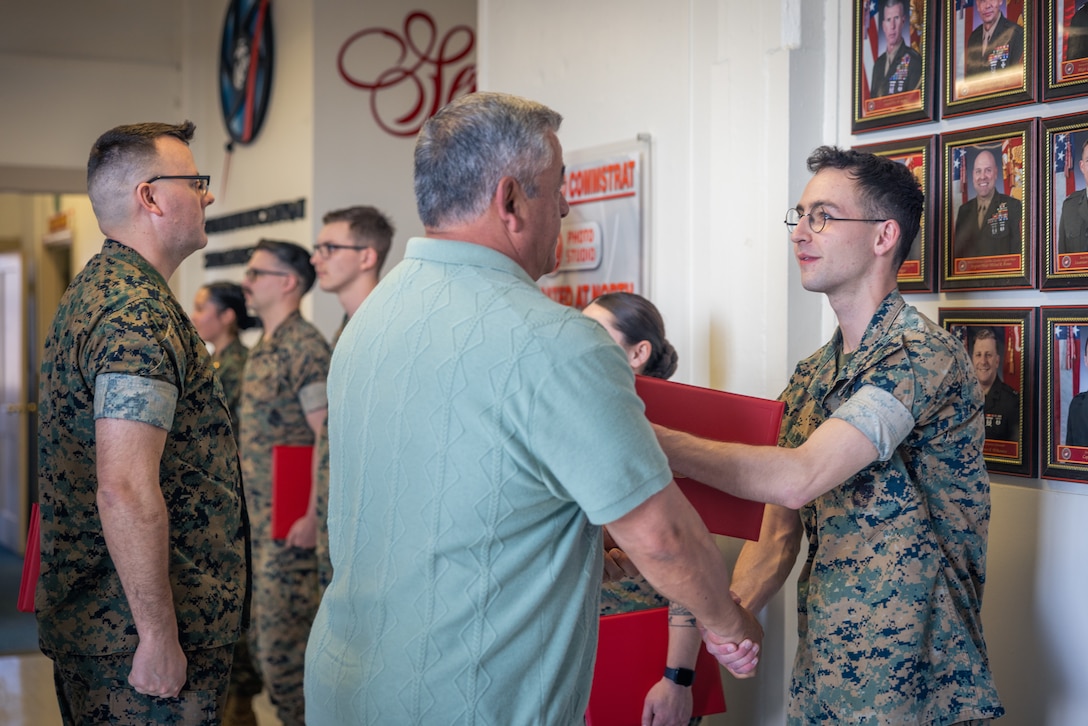 U.S. Marine Corps Lance Cpl. David Brandes, a combat photographer with Communication Strategy and Operations, Marine Corps Base Quantico, receives a certificate during an awards ceremony on MCB Quantico, Virginia, March 10, 2025. Several Marines and civilian Marines were awarded a Certificate of Appreciation due to their participation during the State Funeral of James Carter Jr., the 39th President of the United States. (U.S. Marine Corps photo by Lance Cpl. Joaquin Dela Torre)