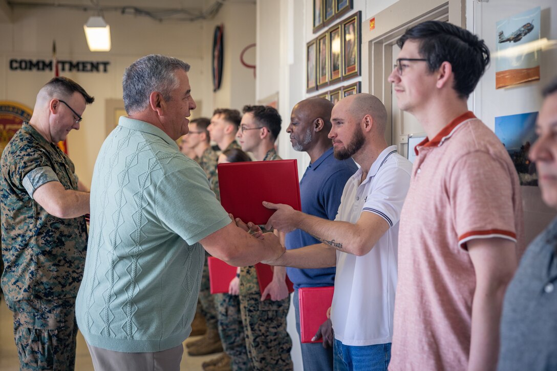 Shaehmus Sawyer, senior writer and editor with Communication Strategy and Operations, Marine Corps Base Quantico, receives a certificate during an awards ceremony on MCB Quantico, Virginia, March 10, 2025. Several Marines and civilian Marines were awarded a Certificate of Appreciation due to their participation during the State Funeral of James Carter Jr., the 39th President of the United States. (U.S. Marine Corps photo by Lance Cpl. Joaquin Dela Torre)