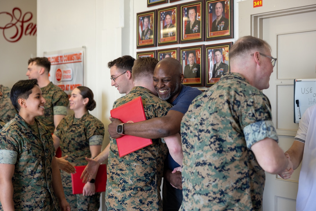 U.S. Marines with Communication Strategy and Operations, Marine Corps Base Quantico, congratulate the awardees during an awards ceremony on Marine Corps Base Quantico, Virginia, March 10, 2025. Several Marines and civilian Marines were awarded a Certificate of Appreciation due to their participation during the State Funeral of James Carter Jr., the 39th President of the United States. (U.S. Marine Corps photo by Lance Cpl. Joaquin Dela Torre)