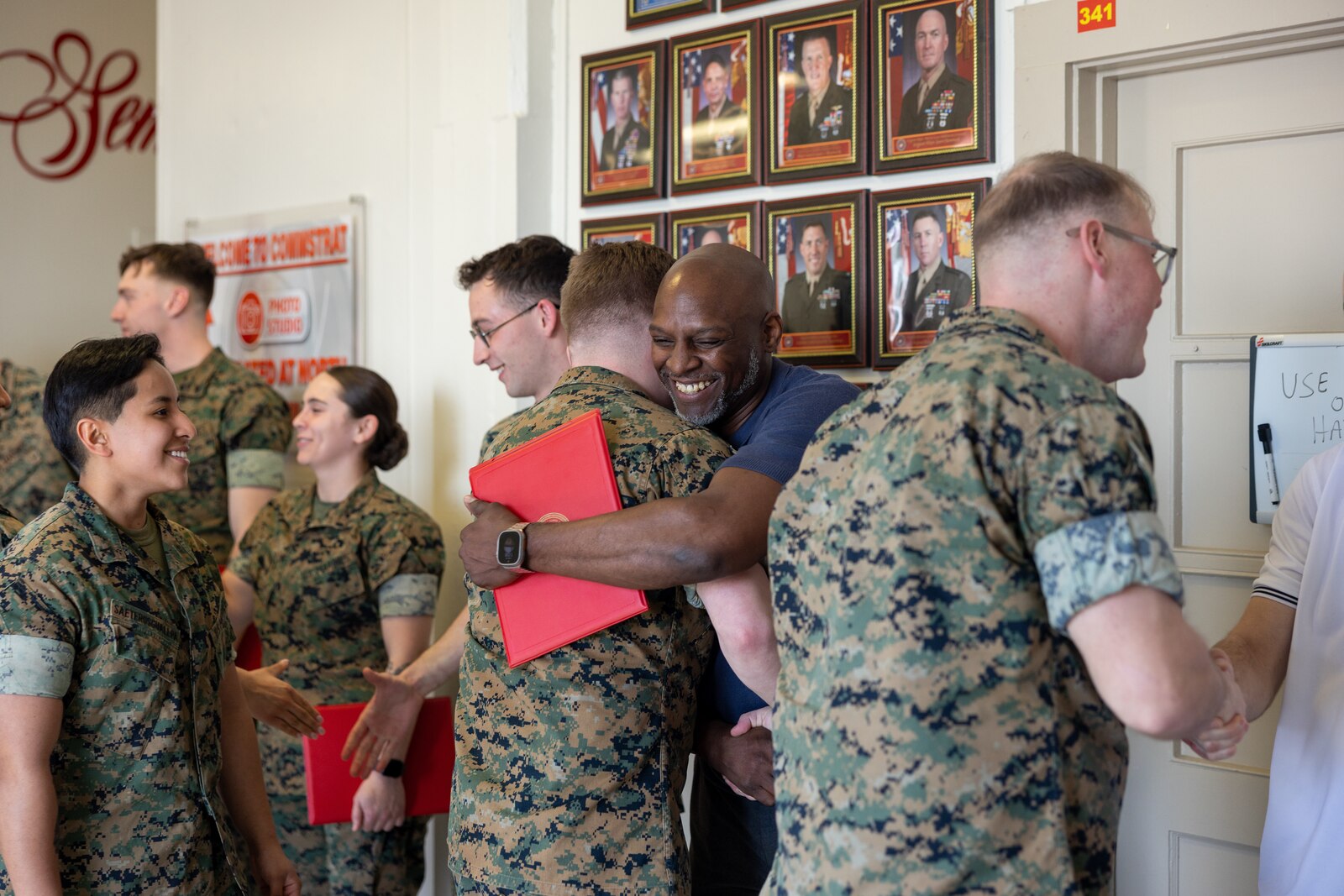 U.S. Marines with Communication Strategy and Operations, Marine Corps Base Quantico, congratulate the awardees during an awards ceremony on Marine Corps Base Quantico, Virginia, March 10, 2025. Several Marines and civilian Marines were awarded a Certificate of Appreciation due to their participation during the State Funeral of James Carter Jr., the 39th President of the United States. (U.S. Marine Corps photo by Lance Cpl. Joaquin Dela Torre)