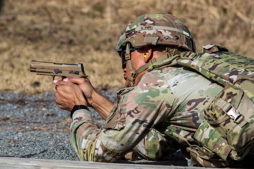 U.S. Army Spc. Tyler Webb, a computer/detection systems repairer with the 2nd Cavalry Regiment, engages targets from the prone position at an excellence-in-competition pistol match at Grafenwoehr Training Area, Germany, March 9, 2025. The competition consisted of two events: a 30-yard slow fire match and a four-stage excellence-in-competition match whereby 10 percent of the top eligible competitors could earn career points toward the Distinguished Pistol Shot Badge. U.S. Soldiers with 2CR and the 7th Army Training Command joined the 56th Stryker Brigade Combat Team at the pistol competition, thus contributing to camaraderie among units, the opportunity to earn career points toward the Distinguished Pistol Shot Badge and improved readiness and lethality in marksmanship training. (U.S. Army National Guard photo by Capt. Leanne Demboski)