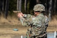 A U.S. Soldier with the 2nd Cavalry Regiment stands to engage a target during an excellence-in-competition pistol match at Grafenwoehr Training Area, March 9, 2025. The competition consisted of two events: a 30-yard slow fire match and a four-stage excellence-in-competition match whereby 10 percent of the top eligible competitors could earn career points toward the Distinguished Pistol Shot Badge. U.S. Soldiers with 2CR and the 7th Army Training Command joined the 56th Stryker Brigade Combat Team at the pistol competition, thus contributing to camaraderie among units, the opportunity to earn career points toward the Distinguished Pistol Shot Badge and improved readiness and lethality in marksmanship training. (U.S. Army National Guard photo by Capt. Leanne Demboski)