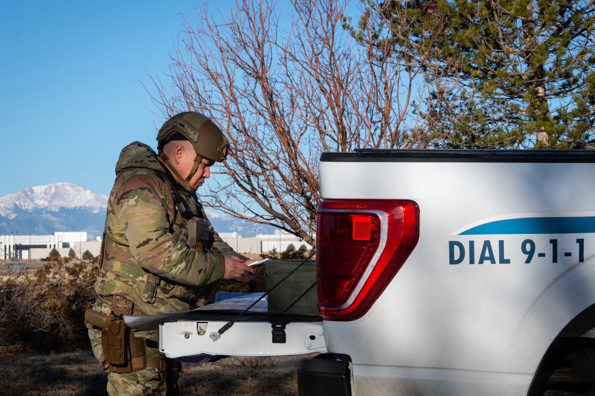 U.S. Technical Sergeant Mark Gerales, security forces member, prepares plans on a map