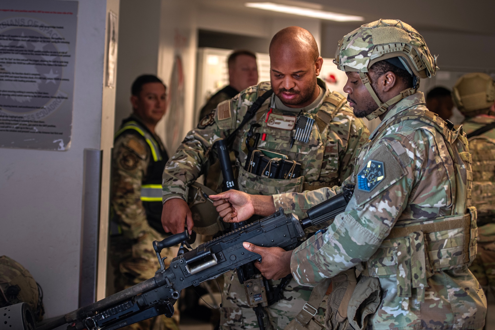 Members of the 50th Security Forces Squadron arrive at the unit's armory to receive weapons for their shift at Schriever SFB