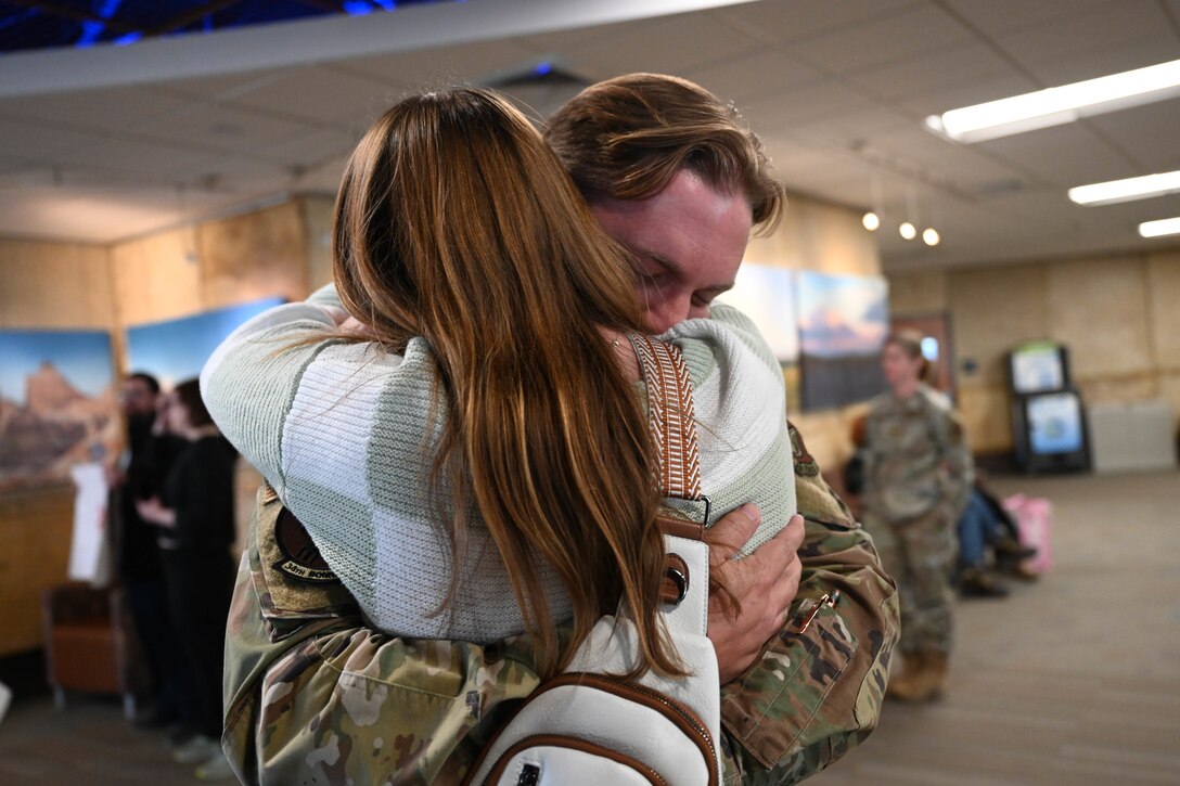 Airman embraces loved one after completing bomber task force mission