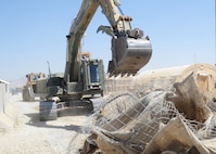 Soldiers with the 687th Engineer C dozer to remove inner force-protection barriers at Forward Operating Base Apache, Zabul Province, Afghanistan, June 30, 2014. The engineers have been in Afghanistan for three weeks and will be deconstructing FOB Apache over the next few months.   (U.S. Army photo by Staff. Sgt. John Etheridge)