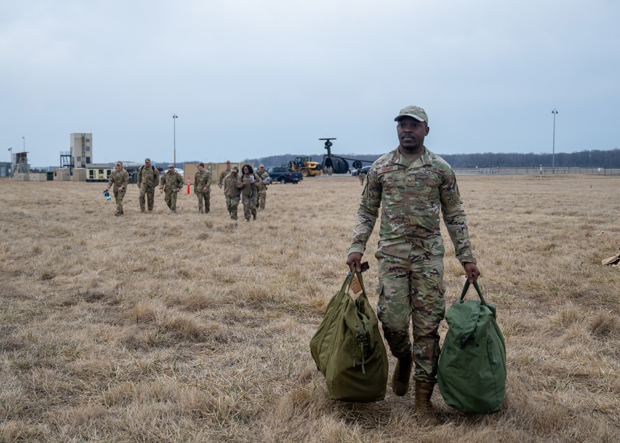 Airman carries equipment