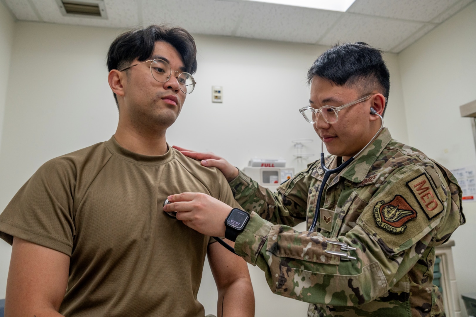 Military doctor conducts a vitals check.