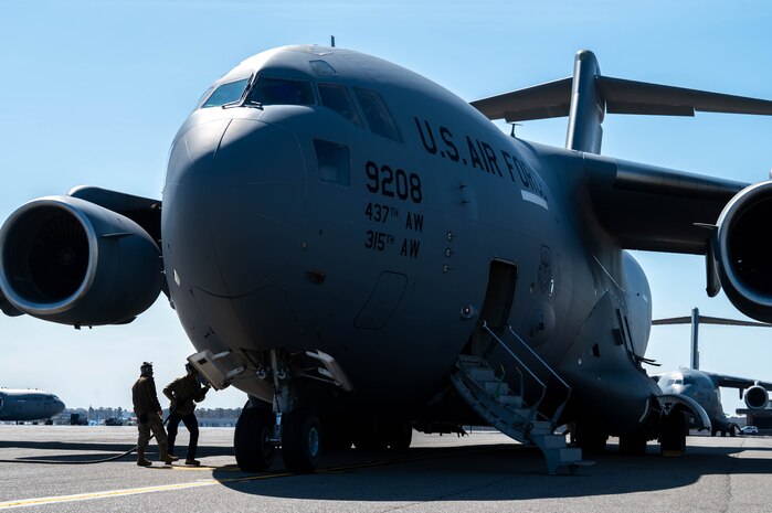 Airmen perform post flight checks on a C-17 Globemaster III cargo aircraft