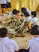 U.S. Army Soldier Staff Sgt. Jaryd Robinson assigned to the 308th Psychological Operations Company engages with local students during an English language class as part of a community outreach event at an Engineering Civic Action Project site 4 Feb. 26, 2025, Ban Chan Khrem, Chanthaburi province, Thailand, during Cobra Gold 25. These engagements foster relationships between U.S. and Thai communities while enhancing cultural understanding. (U.S. Army photo by Sgt. Isaac Copeland)