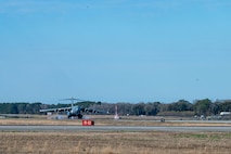 A C-17 Globemaster III cargo aircraft lands on an airfield