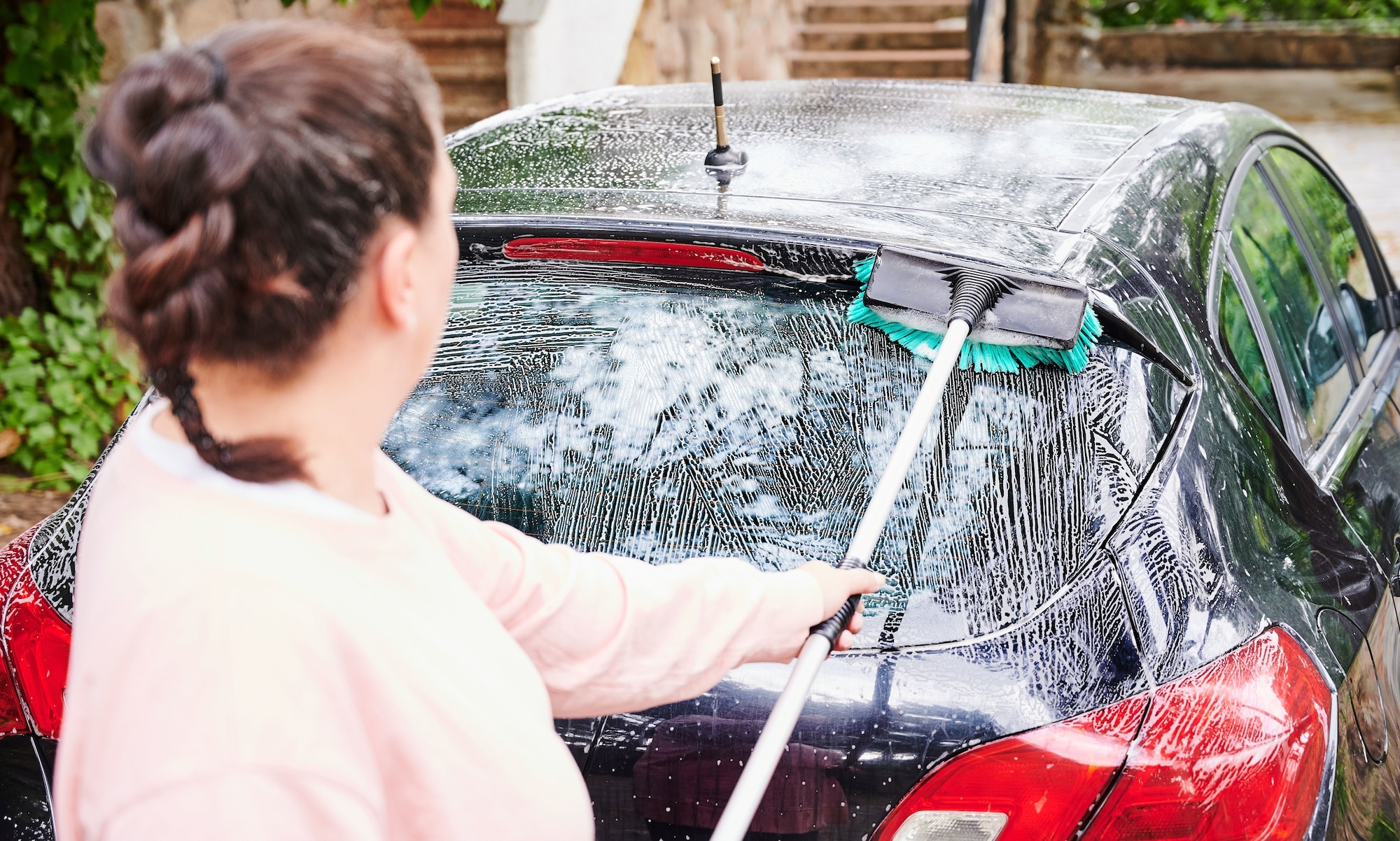Woman washing a car