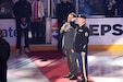 Staff Sgt. David Lietz, 85th U.S. Army Reserve Support Command, public affairs noncommissioned officer, salutes the American flag while Wayne Messmer, professional singer, broadcaster, sings the National Anthem at All-State Arena, March 8, 2025. Lietz was the special guest during a military appreciation event at the Chicago Wolves game against the Grand Rapids Griffins. 
(U.S. Army Reserve photo by Sgt. 1st Class Edgar Valdez)