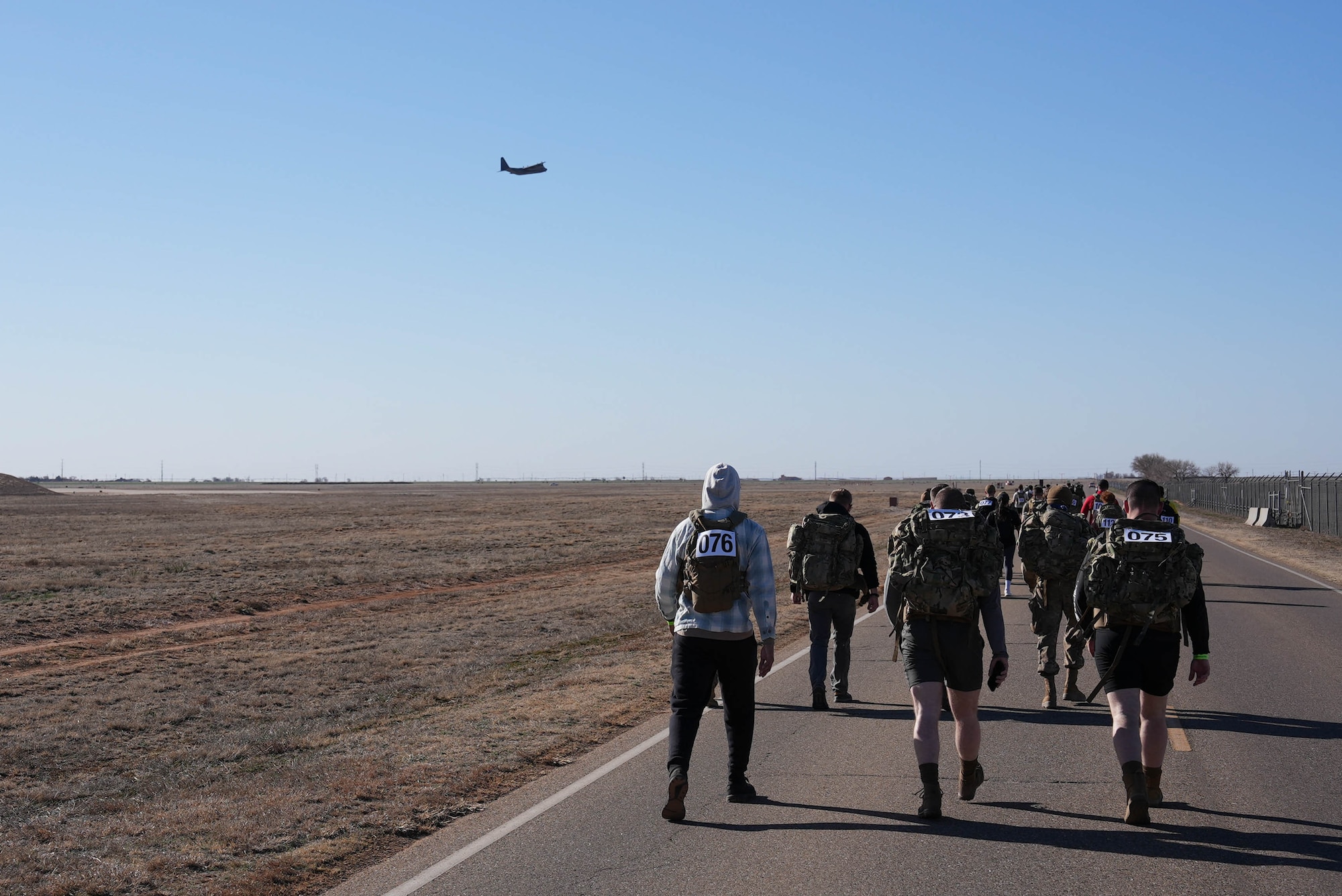 An aircraft flies over the 4th Annual Bataan Memorial March