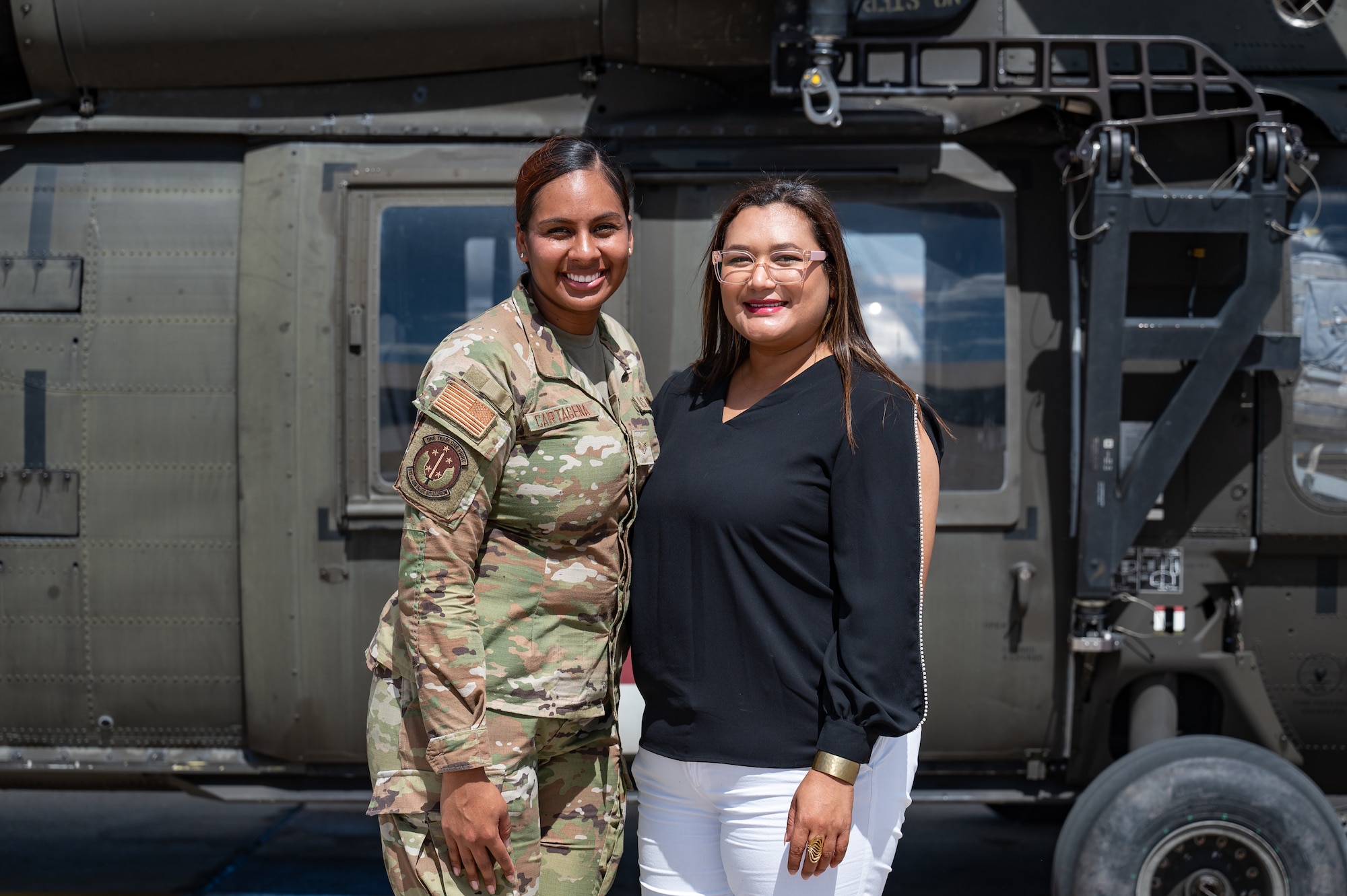 U.S. Air Force Staff Sgt. Karla Cartagena, 612th Air Base Squadron non-commissioned officer in charge of airfield management operations and training, poses for a photo with her aunt after her reenlistment ceremony at Soto Cano Air Base, Honduras, February 5, 2025.