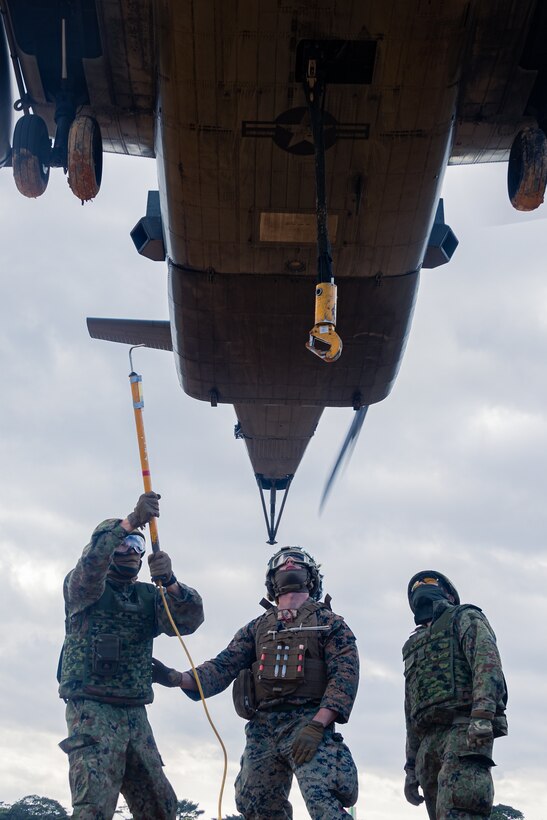U.S. Marine Corps Cpl. Riley Wharton, a logistics specialist with Combat Logistic Company Bravo, Combat Logistics Battalion 31, 31st Marine Expeditionary Unit, center, and Japan Ground Self-Defense Force members with 1st Amphibious Rapid Deployment Regiment, prepare to attach a sling during an external lift exercise in support of Iron Fist 25, at Camp Hansen, Okinawa, Japan, Feb. 22, 2025. Iron Fist is an annual bilateral exercise designed to increase interoperability and strengthen the relationships between the U.S Marine Corps, U.S. Navy and Japan Ground Self-Defense Force. The 31st Marine Expeditionary Unit, the Marine Corps’ only continuously forward deployed MEU, provides a flexible and lethal force, ready to perform a wide range of military operations as the premier crisis response force in the Indo-Pacific region. Wharton is a native of Texas. (U.S. Marine Corps photo by Lance Cpl. Raul Sotovilla)
