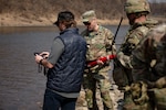 U.S. Army Brig. Gen. Robert "Todd" Brown, 2nd Infantry Division, ROK-US Combined Division, deputy commanding general, learns the control interface of a commercial aquatic drone during Freedom Shield 25 at a training area near the Imjin River in Paju-si, Gyeonggi-do, South Korea, March 11, 2025.  The demonstration showcases the capabilities of cutting-edge underwater vehicles to enhance operational readiness.  Freedom Shield 2025 is a multi-domain military training program that integrates ground, air, naval, space and cyberspace elements, enhancing readiness through realistic combat situations. (U.S. Army photo by Staff Sgt. Eric Kestner)