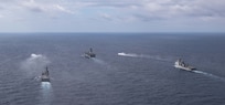 The forward-deployed amphibious assault ship, USS America (LHA 6), center, steams in formation with the amphibious dock landing ship USS Rushmore (LSD 47), right, the Japan Maritime Self-Defense Force (JMSDF) tank landing ship JS Kunisaki (LST-4003), center left, and two JMSDF landing craft during Exercise Iron Fist in the Philippine Sea, Feb. 28.
