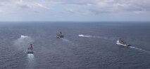 The forward-deployed amphibious assault ship, USS America (LHA 6), center, steams in formation with the amphibious dock landing ship USS Rushmore (LSD 47), right, the Japan Maritime Self-Defense Force (JMSDF) tank landing ship JS Kunisaki (LST-4003), center left, and two JMSDF landing craft during Exercise Iron Fist in the Philippine Sea, Feb. 28.