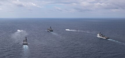 The forward-deployed amphibious assault ship, USS America (LHA 6), center, steams in formation with the amphibious dock landing ship USS Rushmore (LSD 47), right, the Japan Maritime Self-Defense Force (JMSDF) tank landing ship JS Kunisaki (LST-4003), center left, and two JMSDF landing craft during Exercise Iron Fist in the Philippine Sea, Feb. 28.