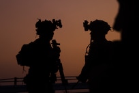 U.S. Marines with Battalion Landing Team 2/4, 31st Marine Expeditionary Unit, communicate with their squad during a simulated boat raid on Recon Beach, Camp Schwab, Okinawa, Japan, Feb. 17, 2025.